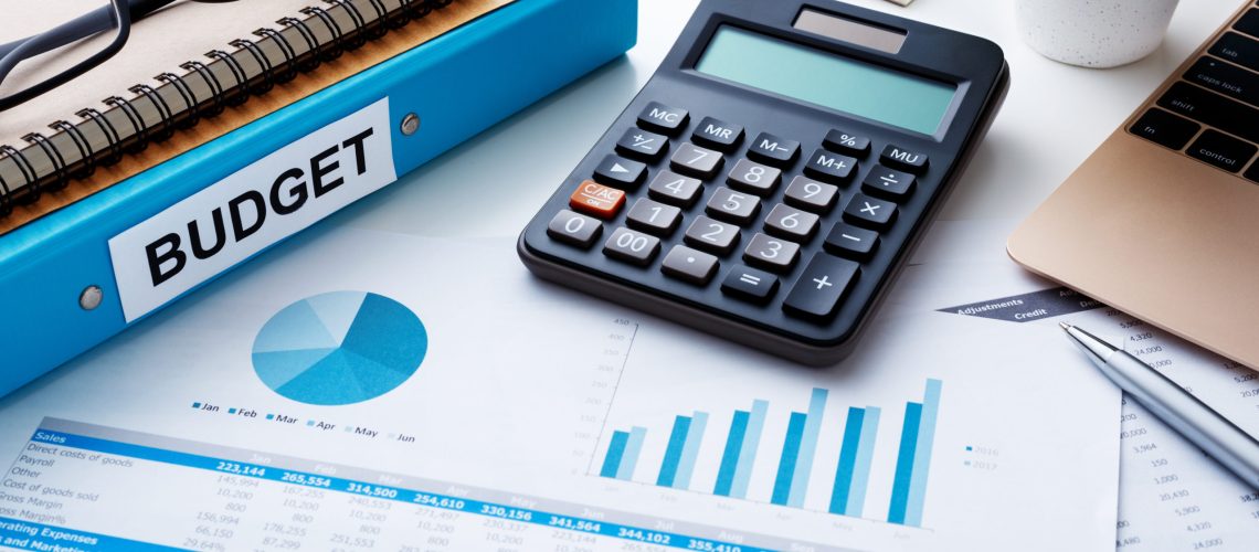 Financial and budget planning concept with calculator  notebook and financial chart report on work desk